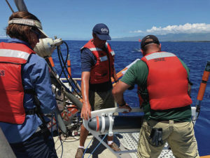 COURTESY UNIVERSITY OF HAWAII
                                Dallas Sherman, left, Eric Attias and Jake Perez check equipment while conducting research in the waters off West Hawaii.