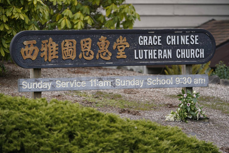 ASSOCIATED PRESS
                                Flowers are shown next to a sign at the Grace Chinese Lutheran Church in Seattle. The church was one of two in the neighborhood that were hit with anti-Asian graffiti earlier in the week, one of several incidents targeting Asian neighborhoods in Seattle this year.