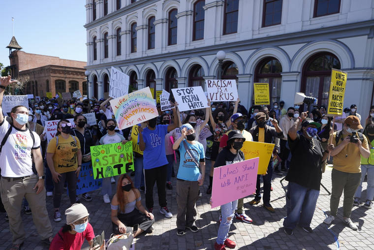 ASSOCIATED PRESS
                                Demonstrators rally against Asian hate crimes in Los Angeles Plaza on Saturday.
