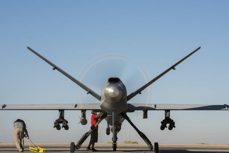 U.S. AIR FORCE PHOTO BY SENIOR AIRMAN DAMON KASBERG
                                Maintainers in 2017 performed final preflight procedures prior to a MQ-9 Reaper, Block 5 variant, taking off in Southwest Asia.