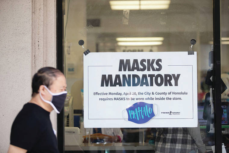 CINDY ELLEN RUSSELL / CRUSSELL@STARADVERTISER.COM
                                A man last week walked past a mask mandate sign in the window of Fisher Hawaii downtown.