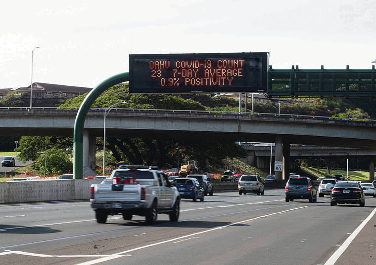 CINDY ELLEN RUSSELL / CRUSSELL@STARADVERTISER.COM
                                COVID-19 statistics were displayed at the Puuloa Road overpass along Moanalua Freeway on Thursday.