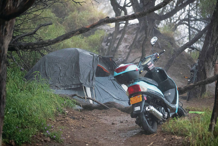 GEORGE F. LEE / GLEE@STARADVERTISER.COM
                                A moped was parked last week near an illegal campsite at Diamond Head Beach Park.
