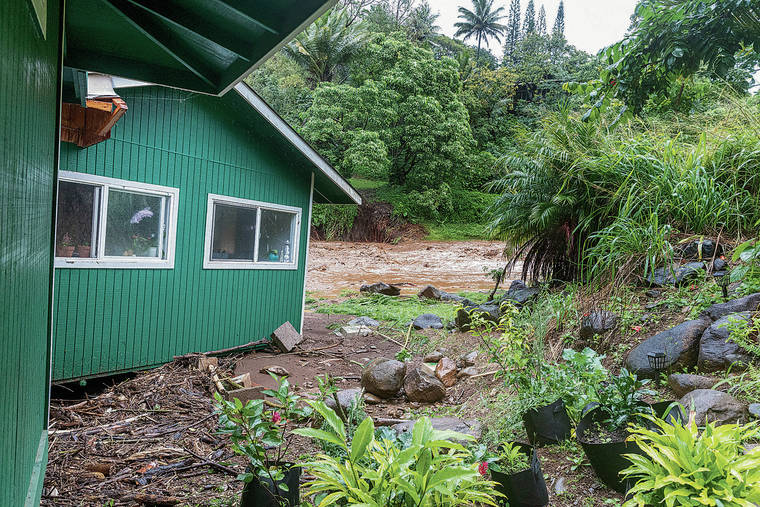 BRYAN BERKOWITZ / SPECIAL TO THE STAR-ADVERTISER
                                A home on Hahana Road in Peahi was flooded and moved a few feet off its foundation Monday after the overtopping of Kaupakalua Dam.