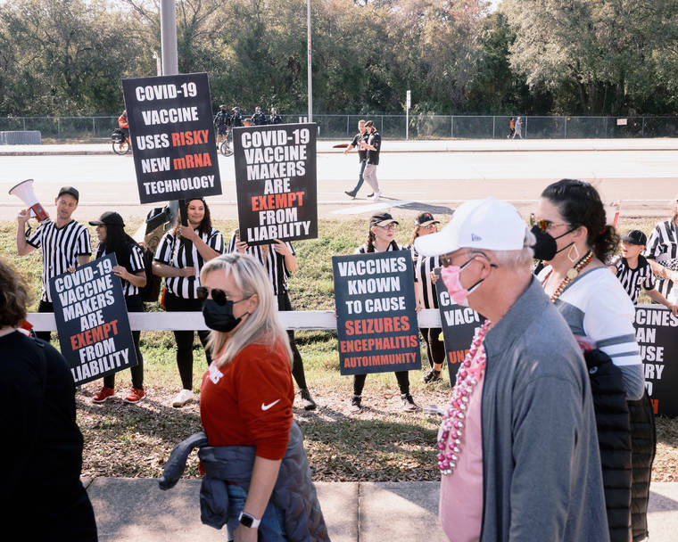 NEW YORK TIMES / FEBRUARY 7
                                Anti-vaccine protestors shout and wave signs at health care workers as they wait in line to enter Raymond James Stadium before Super Bowl LV in Tampa, Fla.