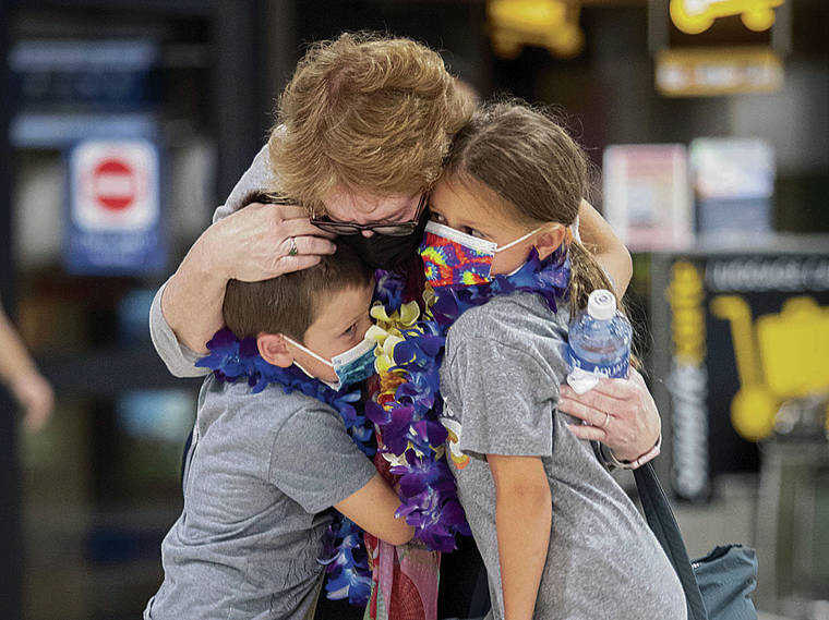 CINDY ELLEN RUSSELL / CRUSSELL@STARADVERTISER.COM
                                Jackie Bornstein on Monday hugged her grandchildren Rigby, almost 5, and Bennett, 6, after her arrival from Los Angeles at Daniel K. Inouye International Airport, above.