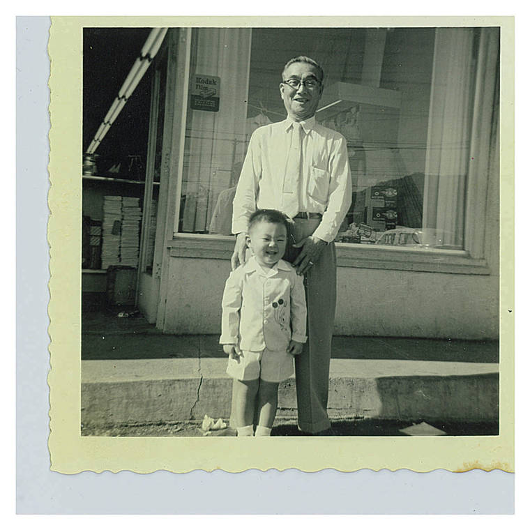 COURTESY YOSHINO FAMILY
                                Naonobu Yoshino, pictured with his grandson Byron, opened Yoshino Drug Store on King and Kaheka streets in 1927.
