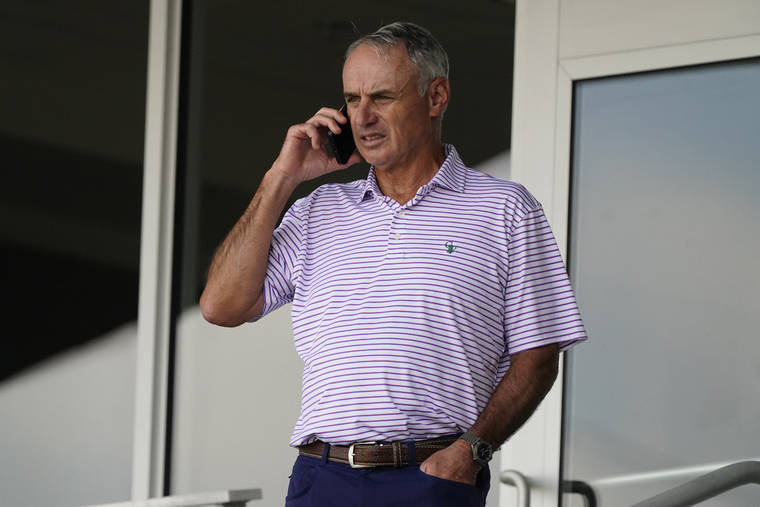ASSOCIATED PRESS
                                Major League Baseball commissioner Rob Manfred spoke on his phone as he watched a spring training baseball game between the Atlanta Braves and Boston Red Sox, March 10, in Fort Myers, Fla.