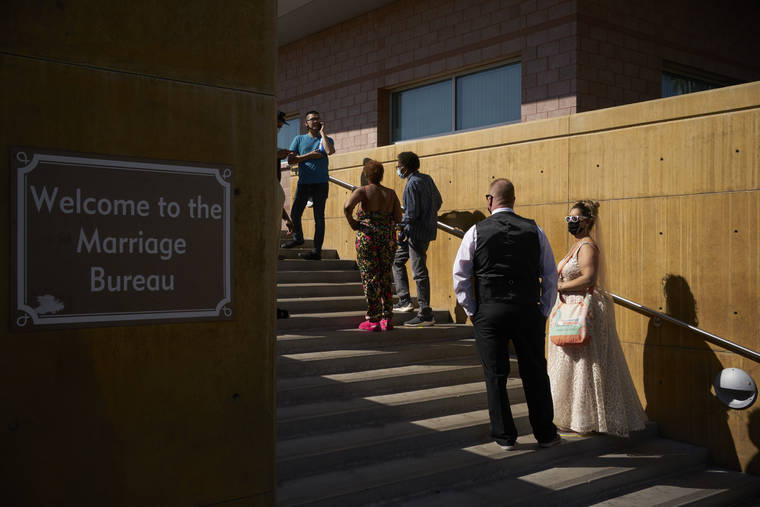 ASSOCIATED PRESS
                                Couples wait in line for marriage licenses at the Marriage License Bureau today in Las Vegas.