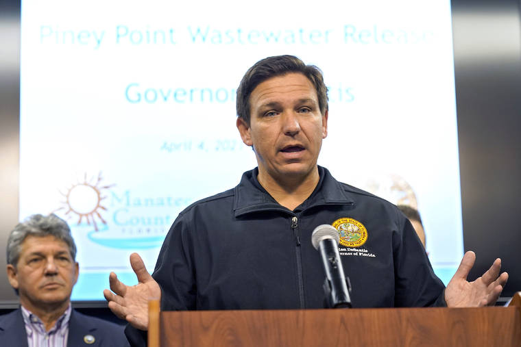 Florida Gov. Ron DeSantis gestures during a news conference Sunday, April 4, 2021, at the Manatee County Emergency Management office in Palmetto, Fla. DeSantis declared a state of emergency Saturday after a leak at a large pond of wastewater threatened to flood roads and burst a system that stores polluted water. (AP Photo/Chris O'Meara)
