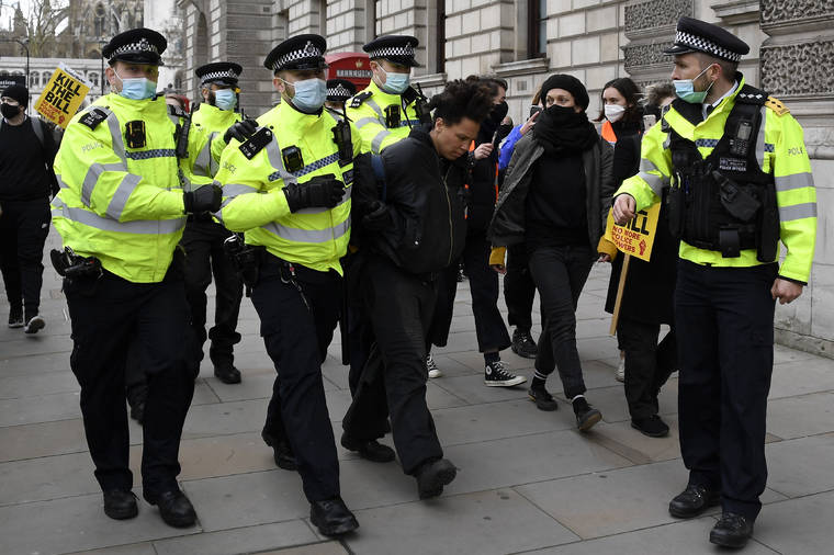 ASSOCIATED PRESS
                                Police detain a man for blocking traffic at Parliament Square during a ‘Kill the Bill’ protest in London on Saturday.