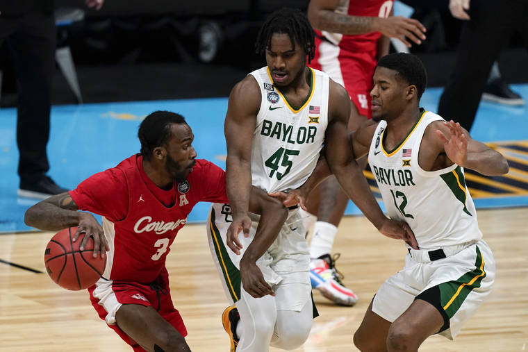 ASSOCIATED PRESS
                                Houston guard DeJon Jarreau (3) drives around Baylor guard Davion Mitchell (45) and guard Jared Butler (12) during the first half of a men’s Final Four NCAA college basketball tournament semifinal game on Saturday in Indianapolis.