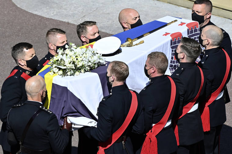 JUSTIN TALLIS/POOL VIA AP
                                Pall bearers carry the coffin arriving at St George’s Chapel for the funeral of Britain’s Prince Philip inside Windsor Castle in Windsor, England. Prince Philip died April 9 at the age of 99 after 73 years of marriage to Britain’s Queen Elizabeth II.
