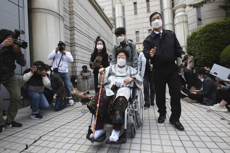 ASSOCIATED PRESS
                                Former South Korean comfort woman Lee Yong-soo in a wheelchair left the Seoul Central District Court in Seoul, South Korea, Wednesday. A South Korean court on Wednesday rejected a claim by South Korean sexual slavery victims and their relatives who sought compensation from the Japanese government over their wartime sufferings.