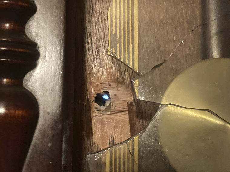 ASSOCIATED PRESS / APRIL 21
                                Daylight shines through a bullet hole in an antique clock on the living room wall of Michael Gordon’s home in Elizabeth City, N.C. Officers trying to serve a warrant on Andrew Brown Jr. fired at him as he was fleeing, striking Gordon’s home.