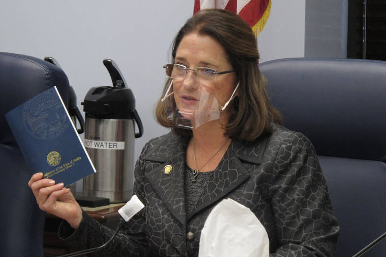 ASSOCIATED PRESS
                                Alaska state Sen. Lora Reinbold, an Eagle River Republican, holds a copy of the Alaska Constitution during a committee hearing in Juneau, Alaska, in January. Alaska Airlines has banned the Alaska state senator for refusing to follow mask requirements. Last week Reinbold was recorded in Juneau International Airport arguing with Alaska Airlines staff about mask policies. A video posted to social media appears to show airline staff telling Reinbold her mask must cover her nose and mouth. Reinbold has been a vocal opponent to COVID-19 mitigation measures and has repeatedly objected to Alaska Airlines’ mask policy, which was enacted before the federal government’s mandate this year.