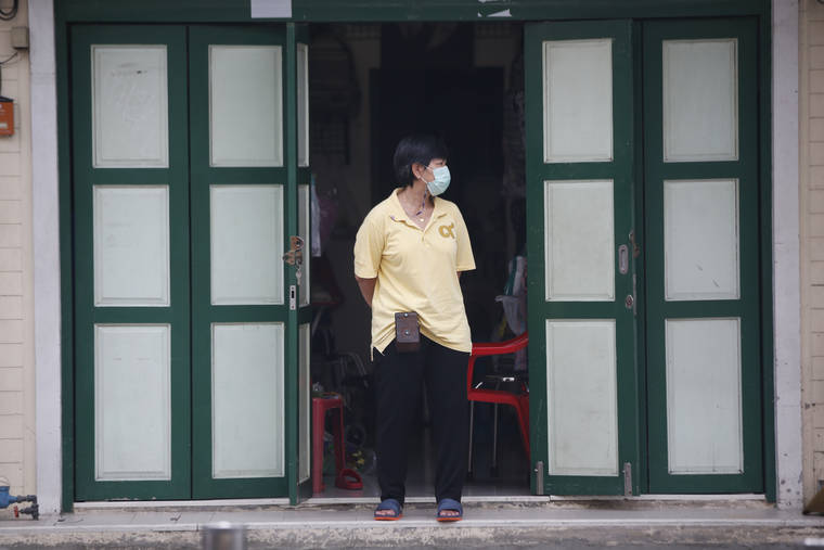 ASSOCIATED PRESS
                                A shop assistant wearing a face mask to help curb the spread of the coronavirus stood in front of her shop in Khao San road, a popular hangout for Thais and tourists in Bangkok, Thailand, Monda.