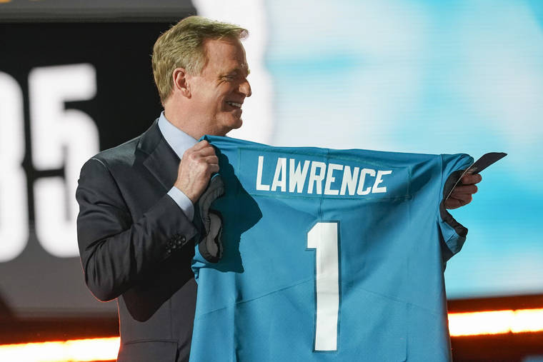 ASSOCIATED PRESS
                                NFL Commissioner Roger Goodell holds a Jacksonville Jaguars jersey as he announces that the Jaguars had chosen Clemson quarterback Trevor Lawrence with the first pick in the NFL football draft today in Cleveland.