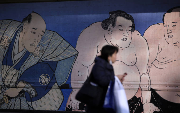 ASSOCIATED PRESS
                                A woman walked past a sumo mural, Nov. 2016, at the Ryogoku Kokugikan, Japan’s national sumo stadium, in Tokyo. A Japanese sumo wrestler died of acute respiratory failure, Wednesday, after suffering a head injury during his bout in a tournament last month, in a case that brought sumo’s emergency response into question.