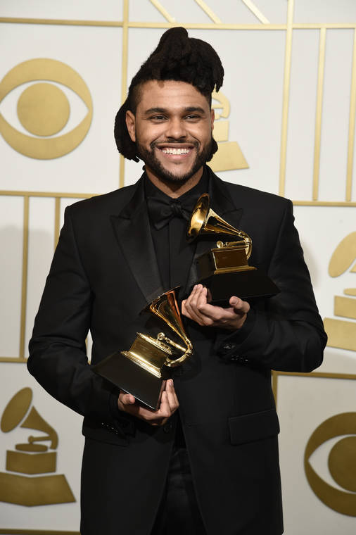 CHRIS PIZZELLO/INVISION/ASSOCIATED PRESS
                                The Weeknd posed in the press room with the awards for best R&B performance for “Earned It (Fifty Shades of Grey)” and best urban contemporary album for “Beauty Behind The Madness” at the 58th annual Grammy Awards in Los Angeles on Feb. 15, 2016.