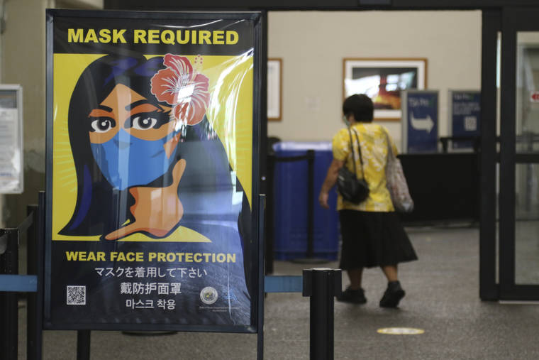 ASSOCIATED PRESS
                                A woman walked into the international airport in Honolulu, Oct. 2, amid a quarantine rule that effectively shut down the tourism industry in the state. If you’re traveling on a plane, train or bus, don’t put that face mask away yet.