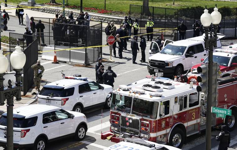 ASSOCIATED PRESS
                                Police and fire officials stood near a car that crashed into a barrier on Capitol Hill in Washington, today.
