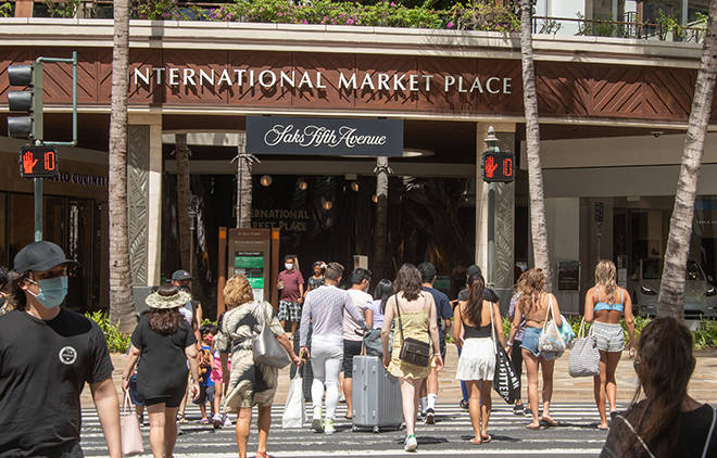 CRAIG T. KOJIMA / CKOJIMA@STARADVERTISER.COM
                                Although still far below pre-pandemic levels, visitors have been returning to Waikiki in greater numbers in recent weeks. Pedestrians filled a crosswalk Saturday at Kalakaua Avenue near the International Market Place.