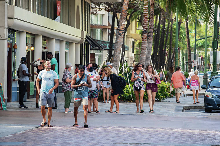 CINDY ELLEN RUSSELL / CRUSSELL@STARADVERTISER.COM / NOV. 8 
                                “We’re going to go back to the same old ways of milking the tourism cow,” said state Sen. Glenn Wakai. People walk and gather along Kalakaua Avenue.