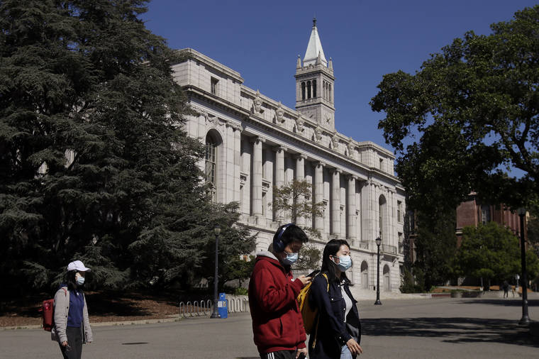 ASSOCIATED PRESS / 2020
                                People wear masks while walking past Wheeler Hall on the University of California campus in Berkeley, Calif.