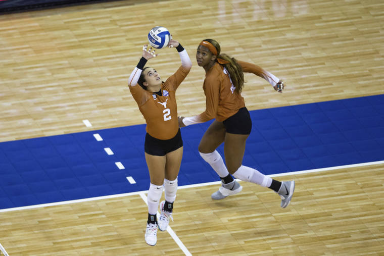 ASSOCIATED PRESS
                                Texas’ Jhenna Gabriel sets the ball for Asjia O’Neal during the first set against Wisconsin.