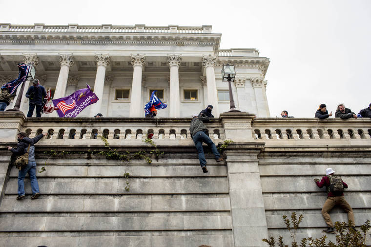 NEW YORK TIMES / JANUARY 6
                                People climb a wall on the Senate side of the U.S. Capitol as a protest by Trump supporters turns into a riot and violent storming of the building, in Washington.