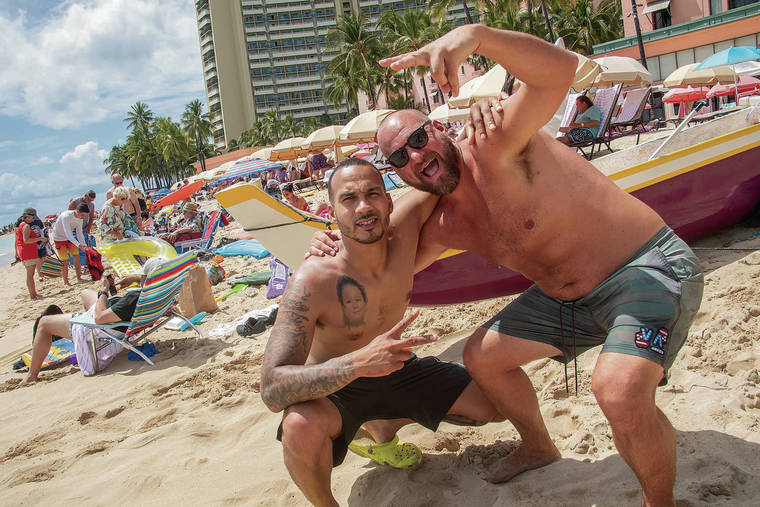CRAIG T. KOJIMA / CKOJIMA@STARADVERTISER.COM
                                Anthony Arjoan, left, and Zach Sheets, partied on Waikiki Beach.