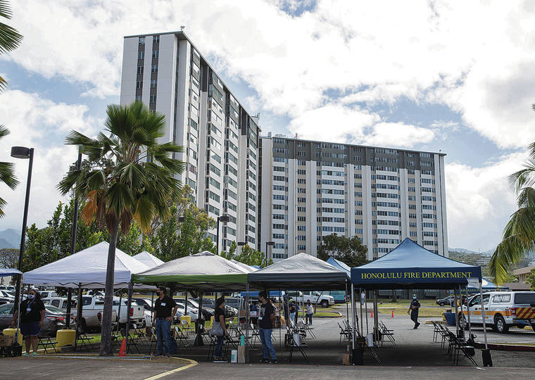 CINDY ELLEN RUSSELL / CRUSSELL@STARADVERTISER.COM
                                A pop-up COVID-19 vaccination clinic was held Thursday at the Towers at Kuhio Park in Kalihi with health care workers from Kaiser Permanente. Above, rows of tents were set up for patients to sit under after they received their vaccine.