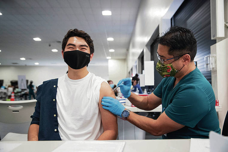 CINDY ELLEN RUSSELL / CRUSSELL@STARADVERTISER.COM
                                Monday marked the first day that people in Hawaii who are 16 or older could receive the vaccine. Tanner Teruya, 19, received a COVID-19 vaccine Monday at Pier 2 from his father, Tyler Teruya, who is an employee health nurse with Hawaii Pacific Health.
