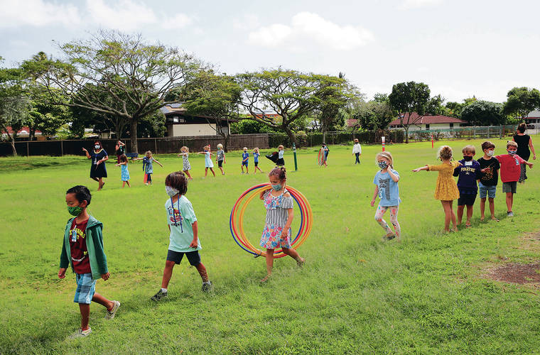 JAMM AQUINO / JAQUINO@STARADVERTISER.COM
                                Aikahi Elementary is among the many public schools that will offer free summer learning programs. First graders at the Kailua school employ social distancing while walking back to class after recess March 22.