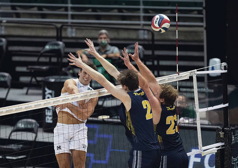 CINDY ELLEN RUSSELL / CRUSSELL@STARADVERTISER.COM 
                                Hawaii outside hitter Colton Cowell scored a kill off San Diego middle blocker Logan Clark, left, and setter Blake Crisp during the second set on Friday.