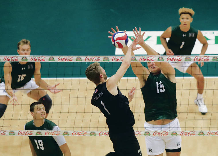 JAMM AQUINO / JAQUINO@STARADVERTISER.COM 
                                Hawaii middle blocker Patrick Gasman got himself in perfect blocking position against Long Beach State middle blocker Shane Holdaway during the first set on Saturday’s match at SimpliFi Arena.