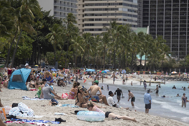 CINDY ELLEN RUSSELL / MAY 7
                                Unmasked beachgoers relax at Waikiki Beach on Friday.