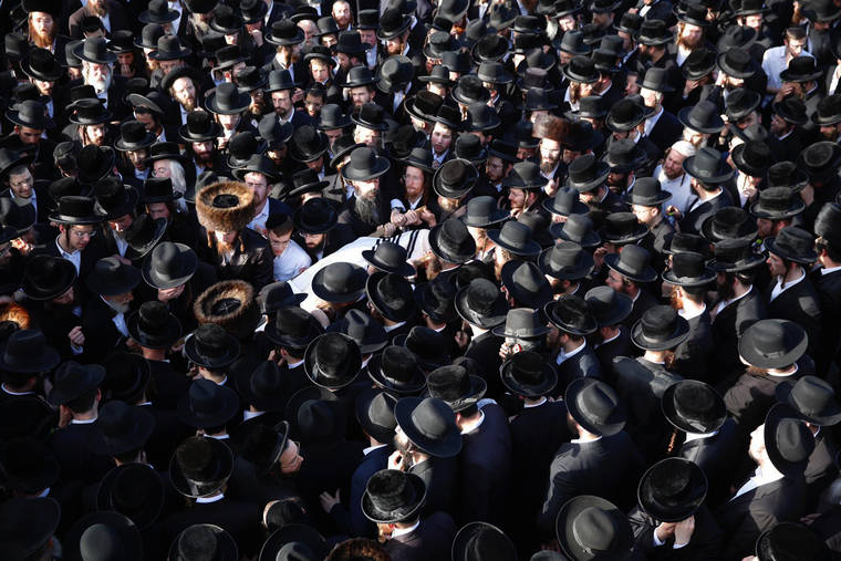 ASSOCIATED PRESS / APRIL 30
                                Mourners carry the body of Shragee Gestetner, a Canadian singer who died during Lag BaOmer celebrations at Mt. Meron in northern Israel, at his funeral in Jerusalem. A stampede at a religious festival attended by tens of thousands of ultra-Orthodox Jews in northern Israel killed dozens of people and injured about 150 others early Friday, medical officials said. It was one of the country’s deadliest civilian disasters.