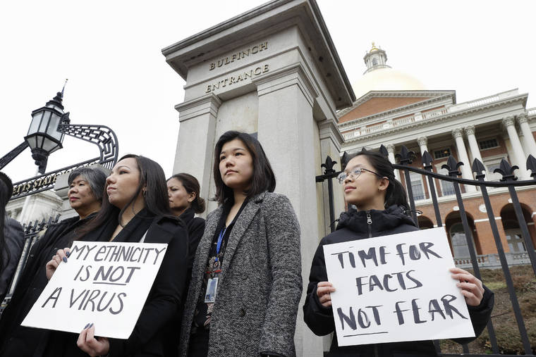ASSOCIATED PRESS
                                Jessica Wong, front left, Jenny Chiang, center, and Sheila Vo, from the state’s Asian American Commission, stood together, in March 2020, during a protest on the steps of the Statehouse in Boston. With a virtual event scheduled for today, Asian American business leaders in the United States are coming together to challenge discrimination against Asian Americans through a historical philanthropic donation.