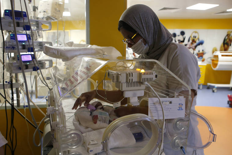 ASSOCIATED PRESS
                                A Moroccan nurse took care of one of the nine babies protected in an incubator at the maternity ward of the private clinic of Ain Borja in Casablanca, Morocco, Wednesday. A Malian woman gave birth to nine babies after expecting only seven.