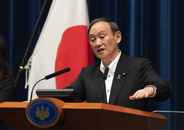 ASSOCIATED PRESS
                                Japanese Prime Minister Yoshihide Suga responded to a reporter’s question after he spoke at a news conference in Tokyo on Friday. Suga announced an extension of a state of emergency in Tokyo and other areas through May 31.