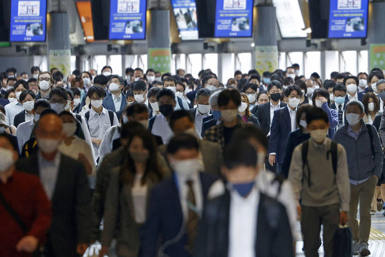 YUTA OMORI/KYODO NEWS VIA ASSOCIATED PRESS
                                Commuters wearing face masks walked through a station passageway in Tokyo Friday. Japan expanded and extended a state of emergency in Tokyo and other areas through May 31 as the coronavirus continues spreading and uncertainty grows about safely holding the Olympics just 11 weeks away.