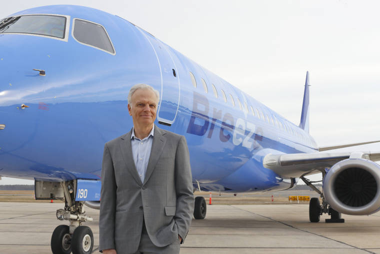 COURTESY CEANORRETT VIA AP
                                JetBlue creator David Neeleman poses next to a Breeze Airways aircraft.