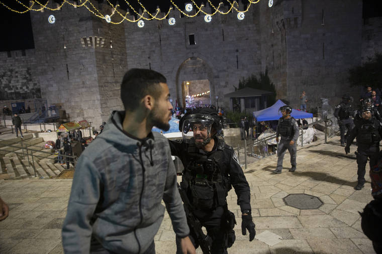 ASSOCIATED PRESS
                                An Israeli policeman shouts at a Palestinian man to leave the Damascus Gate to the Old City of Jerusalem after clashes at the Al-Aqsa Mosque compound today.