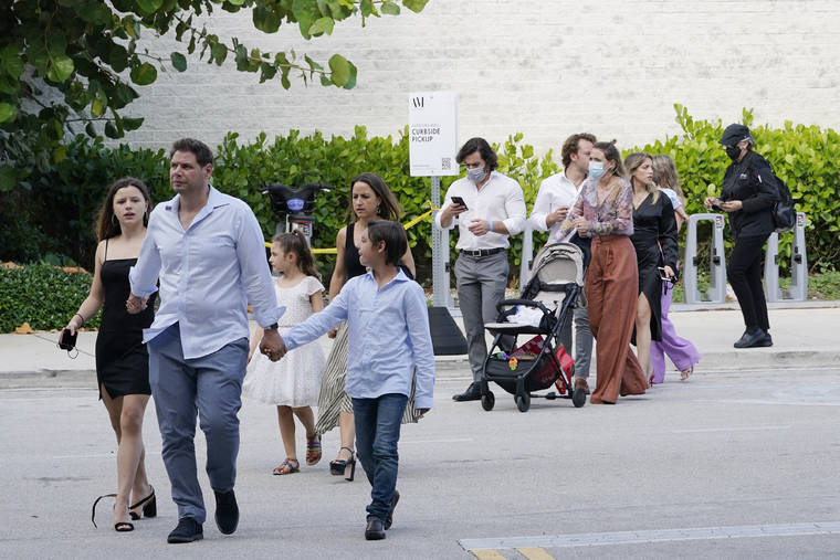 ASSOCIATED PRESS
                                Shoppers who were hiding in stores exit the Aventura Mall after a shooting left three people injured and several suspects in custody in Aventura, Fla. Aventura Police said two groups of people had begun fighting in the mall when shots rang out.