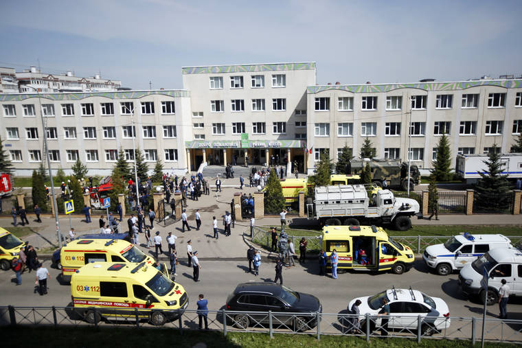 ASSOCIATED PRESS
                                Ambulances and police cars and a truck were parked at a school after a shooting in Kazan, Russia, Tuesday. A gunman launched an attack on a school in the Russian city of Kazan that left at least nine people dead Tuesday — including seven youngsters — and sent students hiding under their desks or running out of the building.