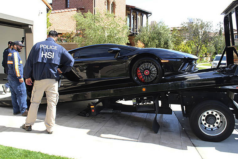 U.S. IMMIGRATION AND CUSTOMS ENFORCEMENT VIA ASSOCIATED PRESS
                                Special agents with HSI Los Angeles’s El Camino Real Financial Crimes Task Force seized a Lamborghini from an Orange County businessman, April 6, in Irvine, Calif. Mustafa Qadiri, 38, of Irvine, was named in a federal grand jury indictment and has pleaded not guilty to charges he obtained $5 million in federal coronavirus-relief loans for phony businesses and then used the money for lavish vacations and to buy a Ferrari, Bentley and Lamborghini, prosecutors said Monday.