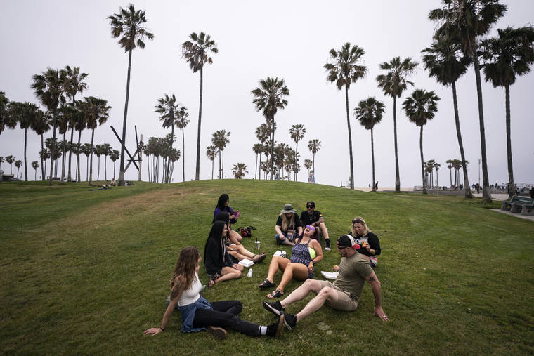 ASSOCIATED PRESS
                                A group of friends, who said they are fully vaccinated for COVID-19, mingle on the beach in the Venice section of Los Angeles last Wednesday.