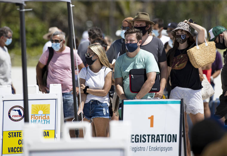 ASSOCIATED PRESS / MAY 2
                                People line up to receive a Johnson & Johnson vaccine at the one-time pop-up vaccination site located 16th Street beach on the sand in Miami Beach.